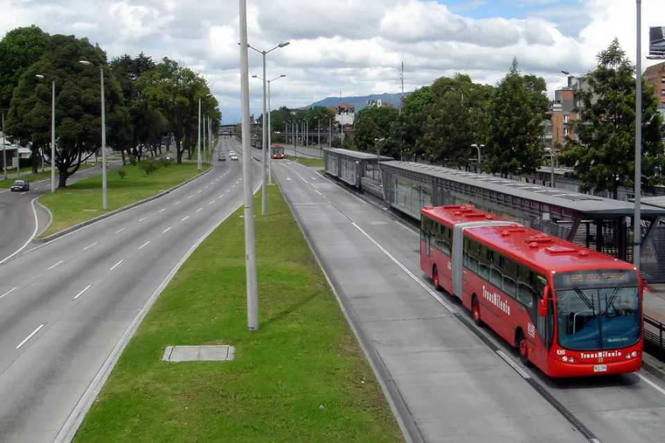 Red transmilenio bus stopped at station in Bogota